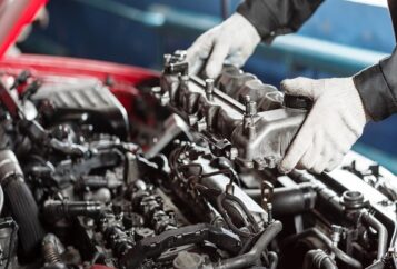 Repairing of modern diesel engine, workers hands and tool. Car mechanic looking at engine for analysis symptoms of car at maintenance repair service station.